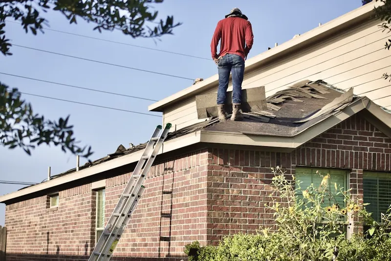 Professional roofer working on a residential roof in Harford